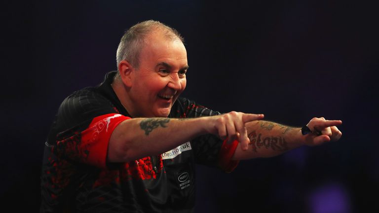 Phil Taylor of England celebrates after scoring 180 during the PDC World Darts Championship final against Rob Cross of England on Day Fifteen at the 2018 William Hill PDC World Darts Championships at Alexandra Palace on January 1, 2018 in London, England.