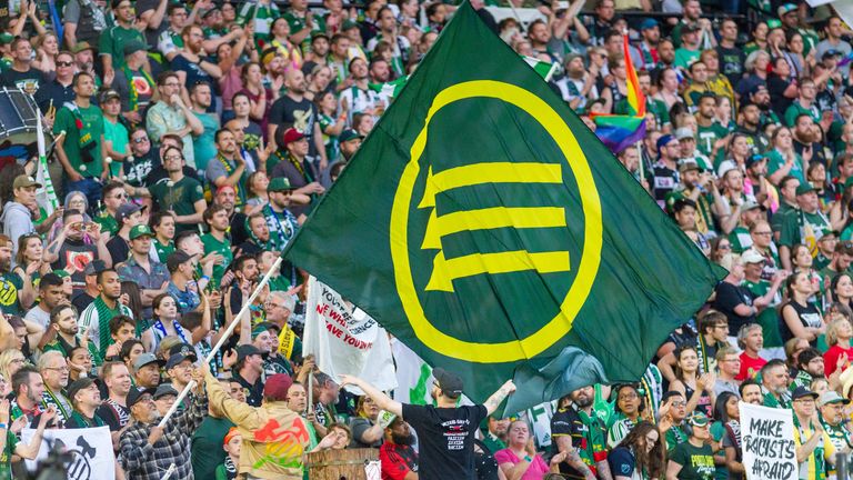 A section of Portland Timbers fans wave a flag featuring the associated with the Iron Front