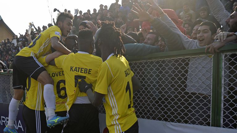 Real Kashmir's players celebrates with fans after scoring in their I-League club football match against Chennai City FC at the Tourist Reception Centre football ground in Srinagar.
