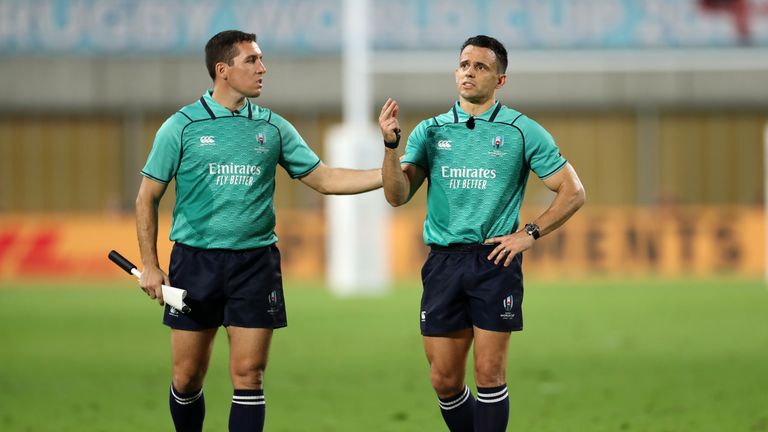 Referee Nic Berry (R) and assistant referee Federico Anselmi (L) look at the replay screen during the Rugby World Cup 2019 Group C game between England and USA 