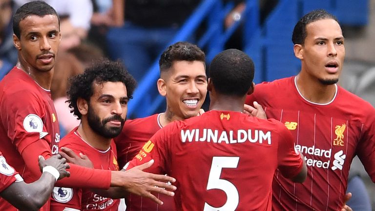 Team-mates congratulate Roberto Firmino after he doubles Liverpool's lead