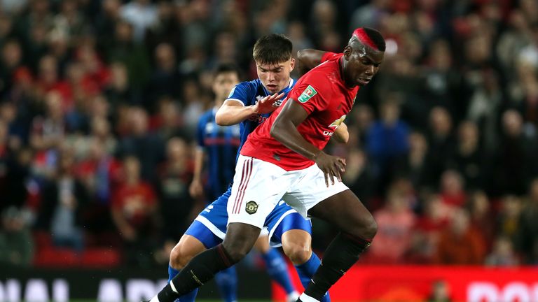 Rochdale's Aaron Morley (left) and Manchester United's Paul Pogba battle for the ball 