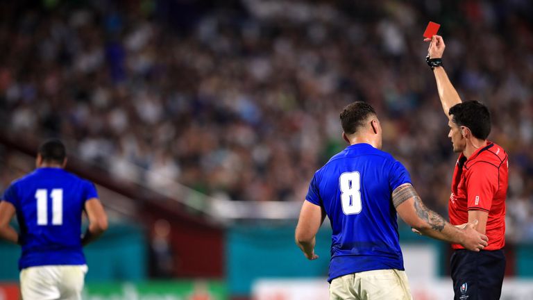 Samoa's Ed Fidow (11) is shown a red card as captain Jack Lam speaks to referee Pascal Gauzere