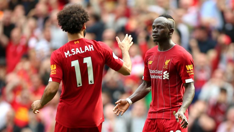 Sadio Mane celebrates scoring his second goal with Mohamed Salah