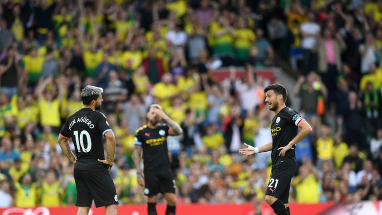 Sergio Aguero and David Silva stand dejected after going a goal down at Carrow Road