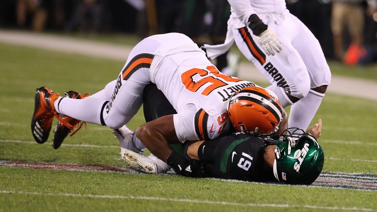 Trevor Siemian of the New York Jets is hurt on this play after he is tackled after a pass by Myles Garrett of the Cleveland Browns