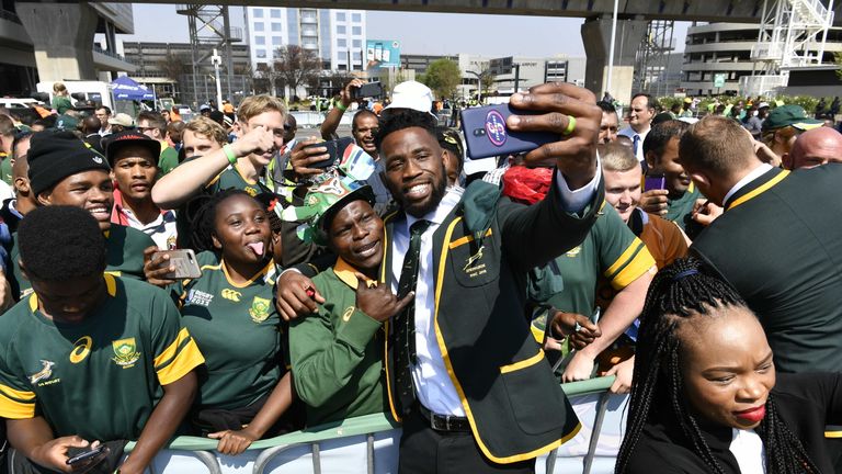 Springbok captain Siya Kolisi takes a selfie with fans during the South African national men's rugby team official send-off at OR Tambo International Airport on August 30, 2019 in Johannesburg, South Africa. 