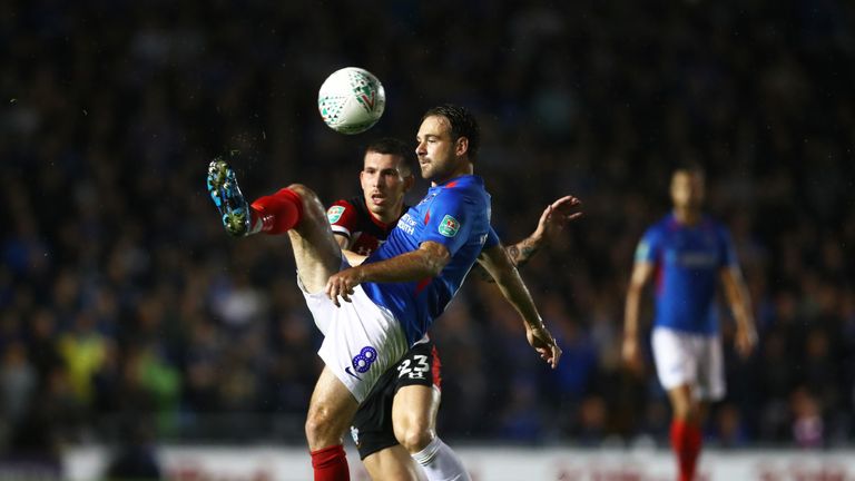 Portsmouth's Brett Pitman challenges for the ball with Southampton's Pierre-Emile Hojbjerg