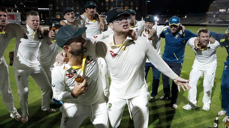 Nathan Lyon and Steve Smith of Australia celebrate with team mates while singing the team song on the pitch after Australia claimed victory to retain the Ashes during day five of the 4th Specsavers Test between England and Australia at Old Trafford on September 08, 2019 in Manchester, England. 
