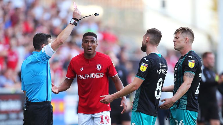 Swansea City's Jake Bidwell (right) is shown a straight red card from Referee Tony Harrington during the Sky Bet Championship match at Ashton Gate, Bristol. PA Photo. Picture date: Saturday September 21, 2019. See PA story SOCCER Bristol City. Photo credit should read: Mark Kerton/PA Wire. RESTRICTIONS: EDITORIAL USE ONLY No use with unauthorised audio, video, data, fixture lists, club/league logos or "live" services. Online in-match use limited to 120 images, no video emulation. No use in betting, games or single club/league/player publications.
