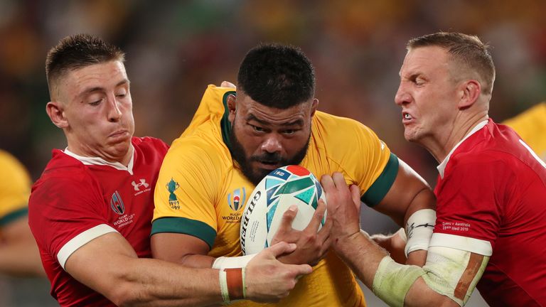 Tolu Latu is tackled by Josh Adams and Hadleigh Parkes