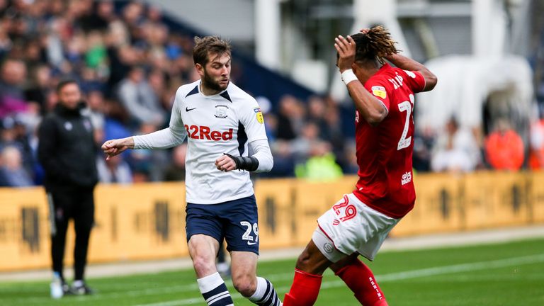 Preston North End's Tom Barkhuizen and Bristol City's Ashley Williams in action at Deepdale