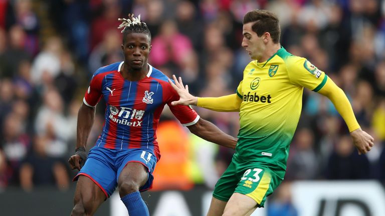 Wilfried Zaha is challenged by Kenny McLean at Selhurst Park