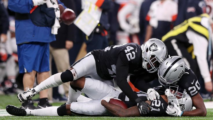 Raiders defenders celebrate with Gareon Conley after his fourth-quarter interception