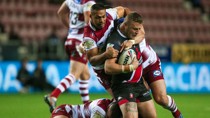 Salford's Josh Jones is tackled by Wigan's Willie Isa, Ben Flower and Ollie Partington