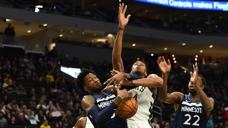Giannis Antetokounmpo battles for a rebound against the Timberwolves