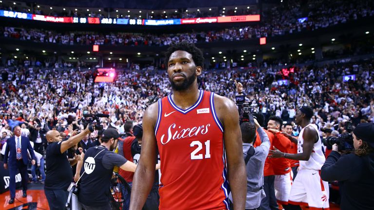 A disconsolate Joel Embiid walks off court following Philadelphia's heartbreaking elimination from the 2018-19 playoffs