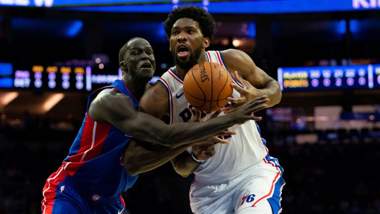 Joel Embiid drives to the basket against Detroit