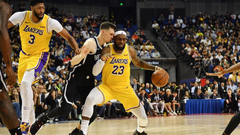LeBron James is guarded by Rodions Kurucs