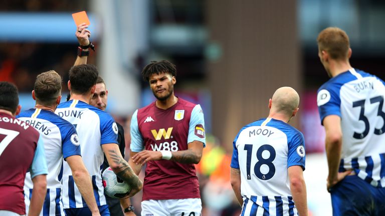 Aaron Mooy is shown a red card for his second bookable offence