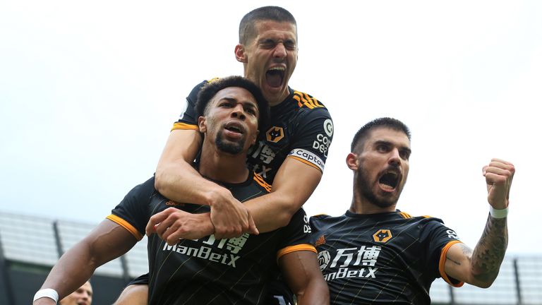 Adama Traore celebrates with Conor Coady and Ruben Neves after scoring the first of his two goals against Man City