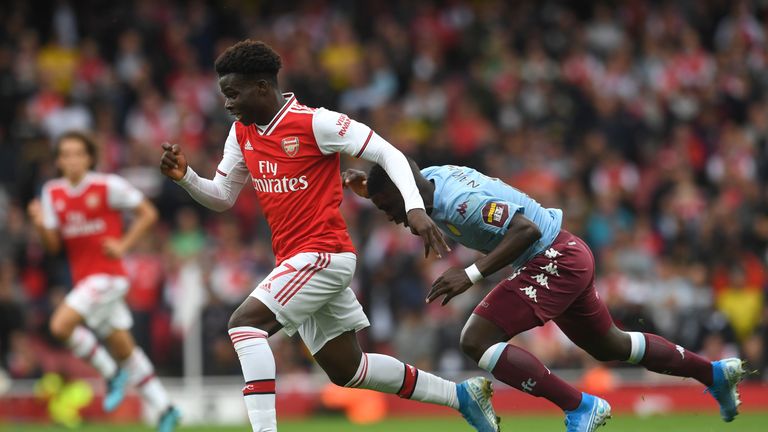Bukayo Saka sprints past an Aston Villa defender at the Emirates Stadium