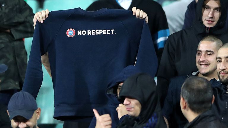 A Bulgaria supporter holds up a sweatshirt with the words No Respect displayed across the chest during the game against England