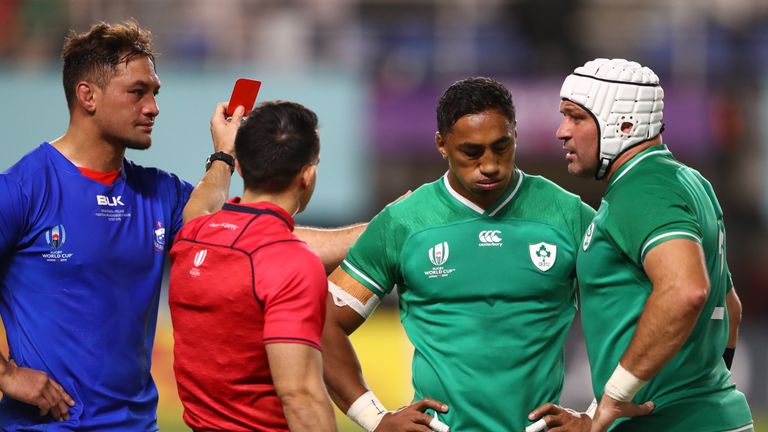 Ireland's centre Bundee Aki (L) receives a red card from referee Nick Berry during the 2019 Rugby World Cup, Pool A match against Samoa