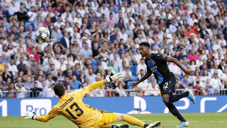 Emmanuel Bonaventure chips Courtois for Club Brugge's second at the Bernabeu.