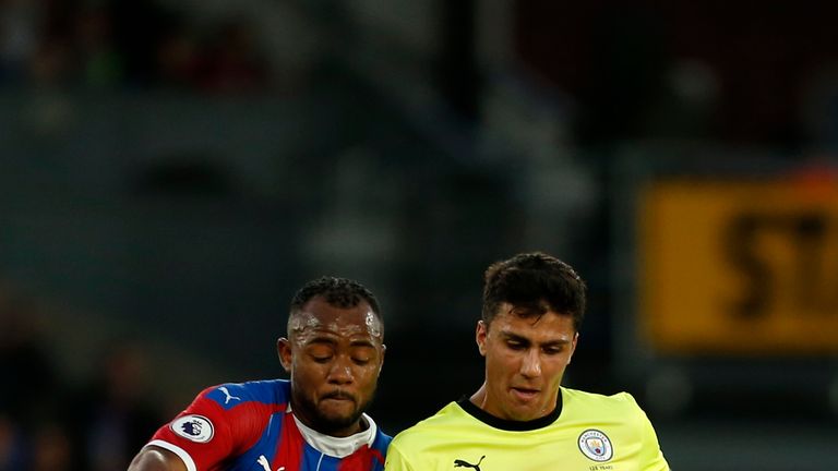 Crystal Palace's Jordan Ayew (L) vies with Manchester City's Rodri