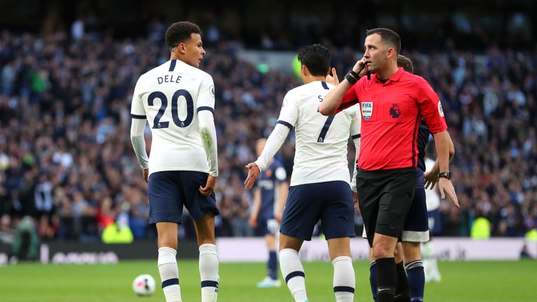 Dele Alli looks at referee Christopher Kavanagh as VAR confuses matters following the midfielder's goal