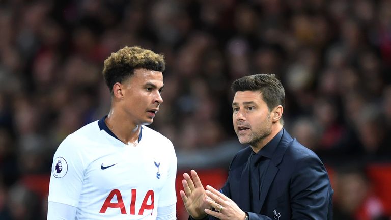 Delle Alli and Mauricio Pochettino of Tottenham Hotspur talking on the touchline