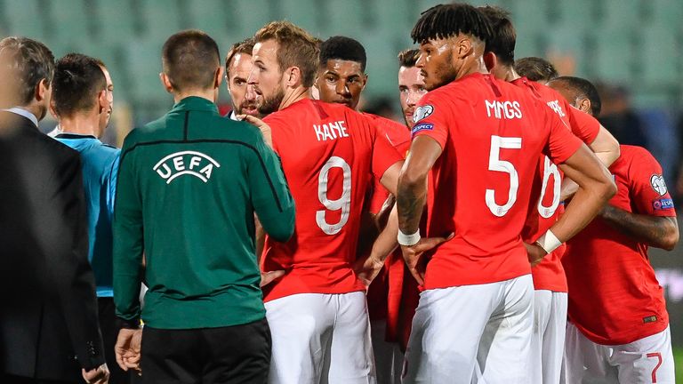 England's forward Harry Kane (C) speaks with the referees during a temporary interruption of the Euro 2020 Group A football qualification match between Bulgaria and England due to incidents with fans, at the Vasil Levski National Stadium in Sofia on October 14, 2019.