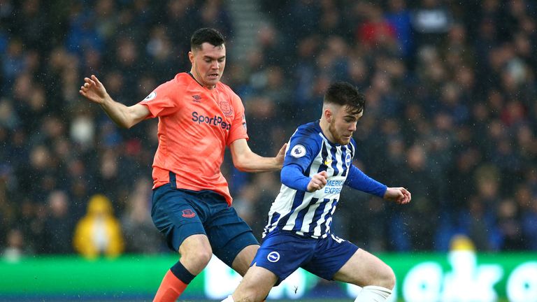Aaron Connolly attempts to get away from Michael Keane