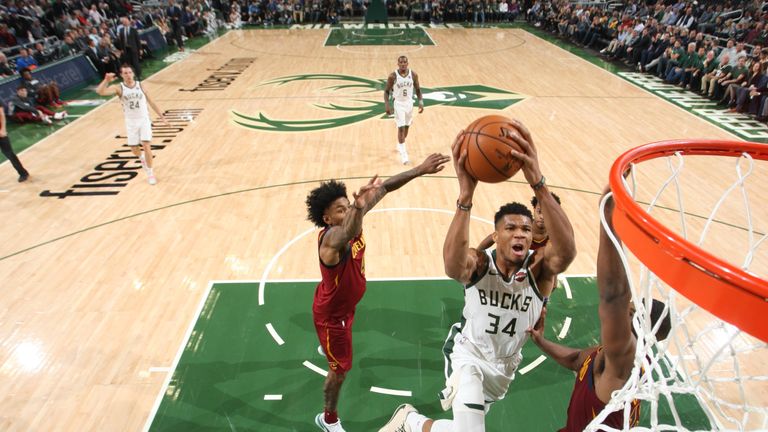 Giannis Antetokounmpo leaves two Cleveland defenders in his wake as he rises to the basket for a dunk