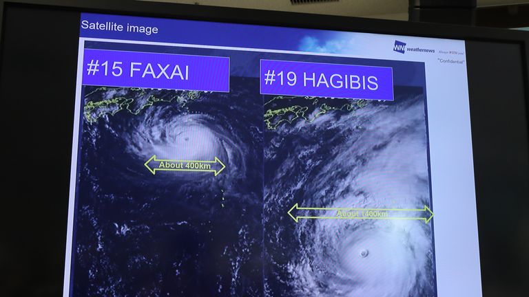 A screen shows the potential impact of super typhoon Hagibis as World Rugby announce match cancellations at a press conference held in Tokyo on October 10, 2019