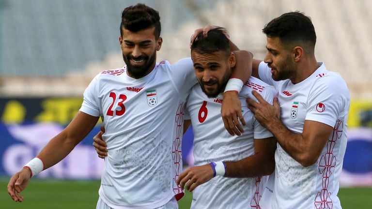 Ahmad Noorollahi (centre) celebrates with his teammates after scoring for Iran