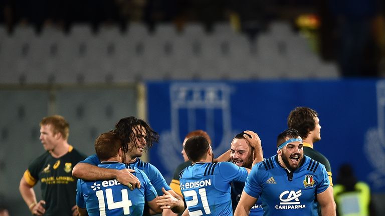 Italy's players celebrate after winning the rugby union Test match between Italy and South Africa at the Artmio Franchi Stadium in Florence on November 19, 2016.