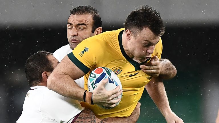 Jack Dempsey is tackled by Georgia's prop Beka Gigashvili (L) and Georgia's flanker Mamuka Gorgodze