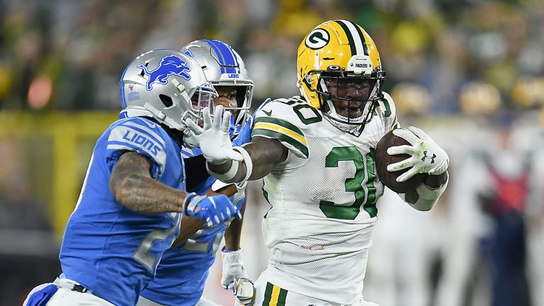 Running back Jamaal Williams #30 of the Green Bay Packers runs against the defense of the Detroit Lions during the game at Lambeau Field on October 14, 2019 in Green Bay, Wisconsin