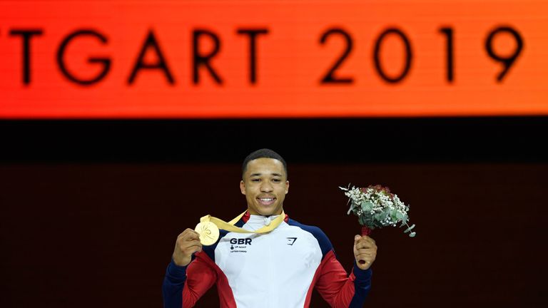 First placed Great Britain&#39;s Joe Fraser celebrates on the podium after the parallel bars event of the apparatus finals at the FIG Artistic Gymnastics World Championships at the Hanns-Martin-Schleyer-Halle in Stuttgart, southern Germany, on October 13, 2019. 