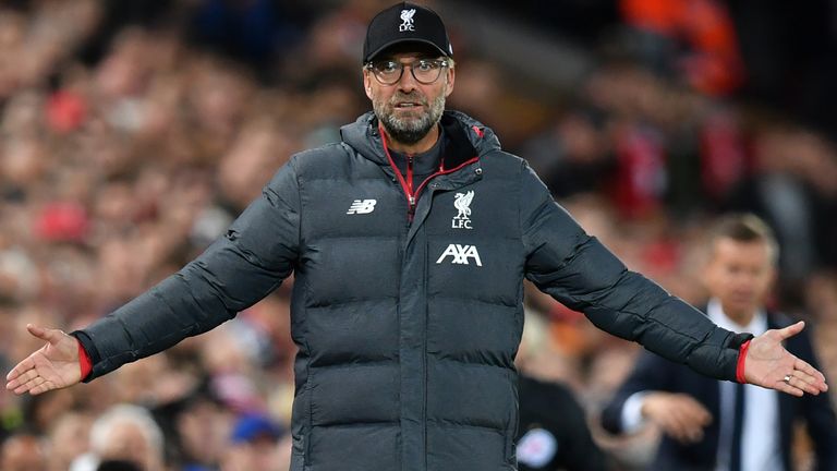 Jurgen Klopp stands arms outstretched during an open Anfield contest