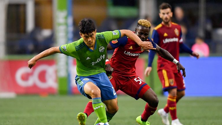 Kim Kee-Hee and Sam Johnson vie for possession during the play-off clash