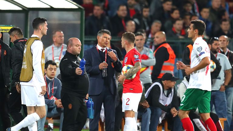 Bulgaria manager Krasimir Balakov speaks with England's Kieran Trippier during a break in play following racist chanting from a section of the home support