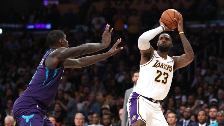 LeBron James of the Los Angeles Lakers shoots past the defense of Marvin Williams of the Charlotte Hornets