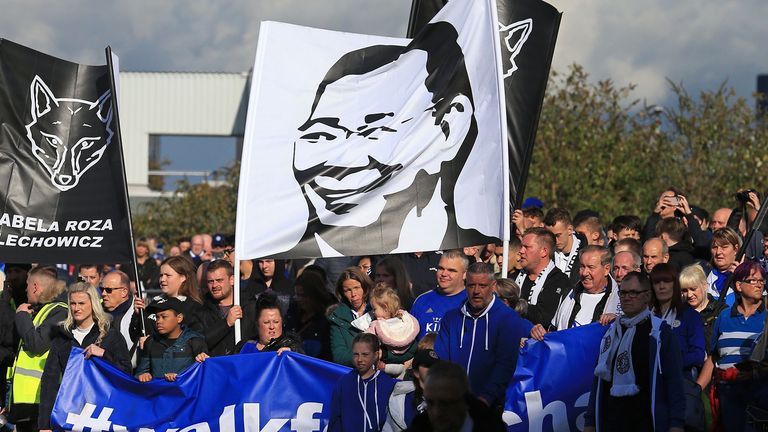 Leicester City supporters take part in a walk to the ground to mark the anniversary of the helicoptor crash that killed the club&#39;s chairman Vichai Srivaddhanaprabha and four others, ahead of the English Premier League football match between Leicester City and Burnley at King Power Stadium in Leicester, central England on October 19, 2019. 