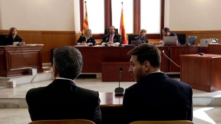 Lionel Messi and his father Jorge  listen as they face judges in a tax fraud case at the courthouse of Barcelona