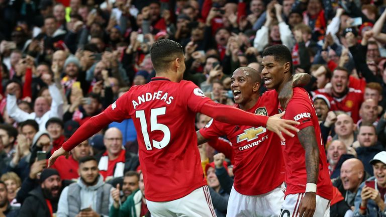 Marcus Rashford celebrates his opening goal against Liverpool