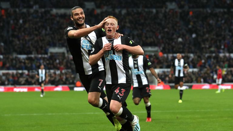 Matty Longstaff of Newcastle United celebrates his opener against Manchester United with team-mate Andy Carroll