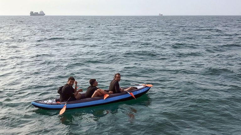 Three migrants who were attempting to cross The English Channel from France to Britain are seen as they drift in an inflatable canoe off the French coast at Calais on August 4, 2018, before being rescued by lifeguards of Les Sauveteurs en Mer (SNSM). (Photo by STR / AFP) (Photo credit should read STR/AFP via Getty Images)